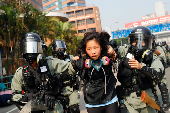 Image: A protester is detained by riot police while attempting to leave the campus of Hong Kong Polytechnic University (PolyU) during clashes with police in Hong Kong