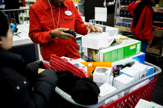 Image: An employee scans merchandise at a Target store in Westbury, N.Y., on Nov. 22, 2018.