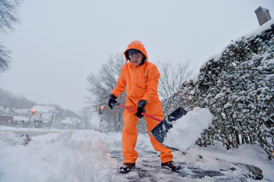 David Chu shovels snow from his sidewalk in front of his home in Malden, Mass., on Dec. 3, 2019.