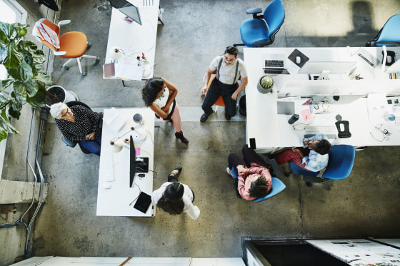 Overhead view of design team having project meeting in office