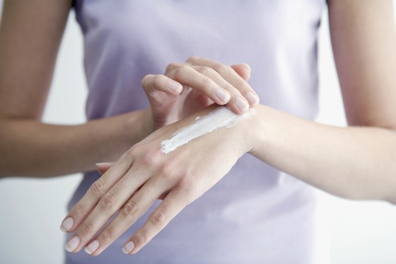 Image: Woman applying cream to hands, close-up