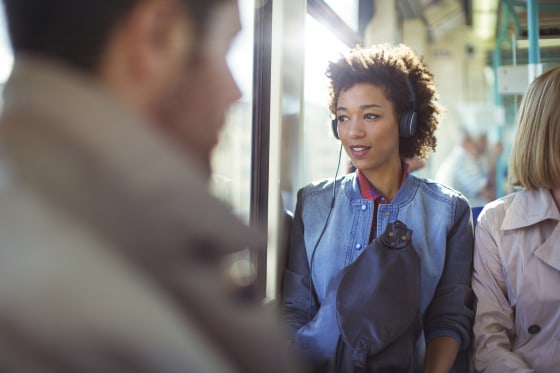Woman listening to headphones on train