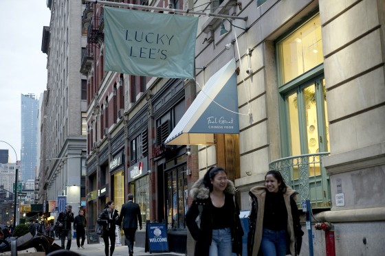 Pedestrians walk past the Lucky Lee's restaurant in the Greenwich Village neighborhood of New York on April 11, 2019.