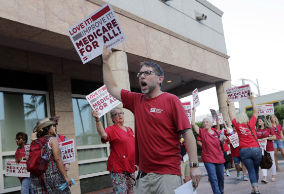 Supporters of medicare for all march outside a Democratic presidential debate in Miami