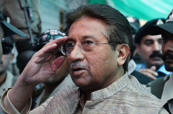 Image: Former Pakistani president Pervez Musharraf is escorted by soldiers as he salutes on his arrival at an anti-terrorism court in Islamabad.