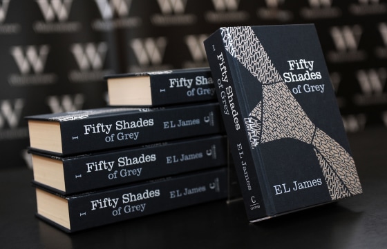 A pile of \"Fifty Shades of Grey\" books by E.L. James