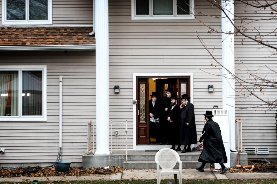 Image: People gather at the residence of a rabbi where five people were stabbed during a Hannukah celebration in Monsey, N.Y., on Dec. 29, 2019.