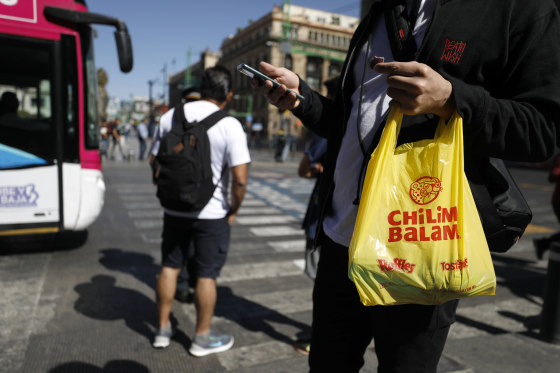 Image: A pedestrian carries a plastic bag after a ban on plastic bags took effect in Mexico City on Jan. 1, 2020.