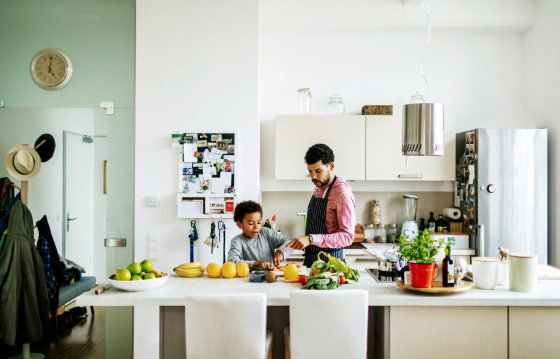 Father And Son Helping Each Other Prepare Some Lunch