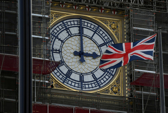 Image: FILE PHOTO: British Union Jack flies in front of the clock face of the clock that houses the Big Ben bell in London