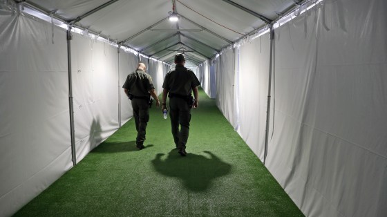 U.S. Border Patrol agents walk down the hallway of a U.S. Customs and Border Protection temporary facility near the Donna International Bridge in Donna, Texas, on May 2, 2019.