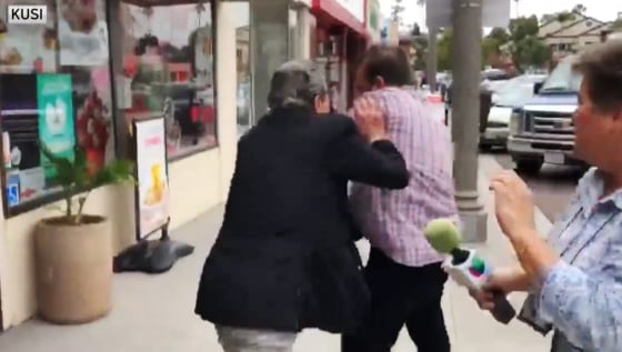 IMAGE: Peter Carzis shoves a journalist