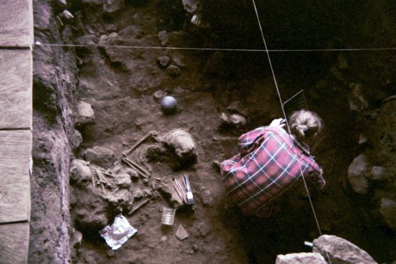 A researcher excavates the ancient bones at the Shum Laka rock shelter, which holds the remains of children who lived about 8,000 and 3,000 years ago.