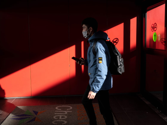 Image: A passenger from China's Hainan Airlines from Beijing walks out of the arrivals gate at the Abelardo L. Rodriguez International airport in Tijuana