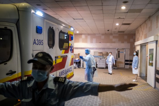 iMAGE: A security official stands guard as an ambulance arrives with a coronavirus patient at Princess Margaret Hospital in Hong Kong on Jan. 22, 2020.