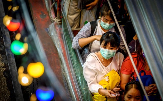 Image: Commuters wear masks to protect against the coronavirus at Pratunam Pier in Bangkok on Jan. 30, 2020.