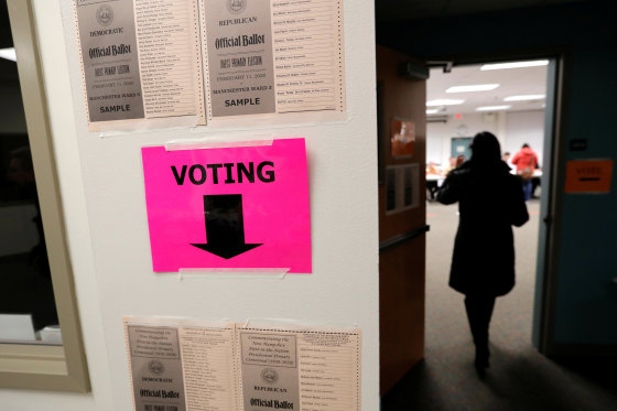 Image: A voter arrives to cast a ballot in the New Hampshire U.S. presidential primary election in Manchester
