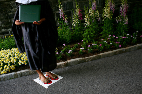 Image: A Sarah Lawrence College graduate poses with her degree in 2009.