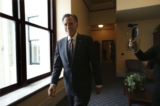 Image: Sen. Mitt Romney, R-Utah, walks through a hallway at the state Capitol in Salt Lake City