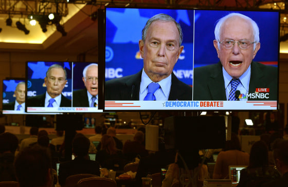 Image: Mike Bloomberg and Senator Bernie Sanders on video screens in the media filing center during the ninth Democratic 2020 U.S. Presidential candidates debate at the Paris Theater in Las Vegas