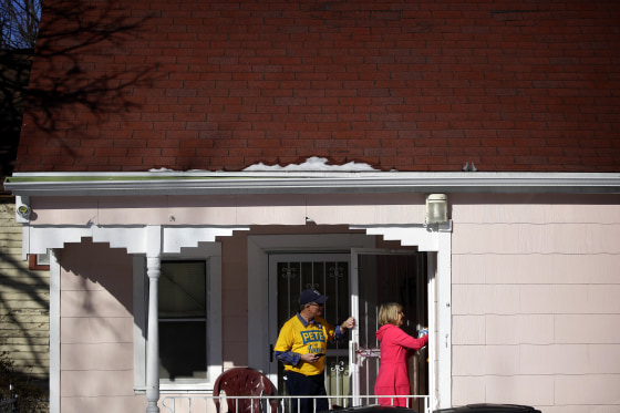 Image: Len Edgerly and Darlene Determan knock on a door while canvasing for Pete Buttigieg in Des Moines, Iowa, on Feb. 2, 2020.
