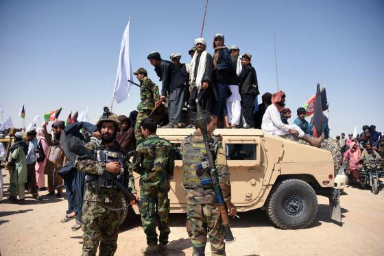 Image: Afghan Taliban militants and residents of Kandahar province