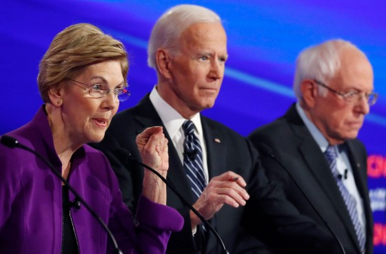 Image: Democratic 2020 presidential candidates Senator Elizabeth Warren speaks with former Vice President Joe Biden and Senator Bernie Sanders listening at the seventh Democratic 2020 presidential debate at Drake University in Des Moines