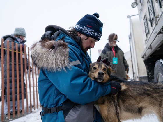 Image: Quince Mountain pets one of the dogs on his team in Anchorage on March 7, 2020.