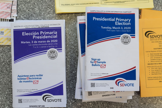 Image: English and Spanish-language sample ballots and voter information pamphlets for the California Democratic presidential primary are seen at a polling place in Del Mar, California