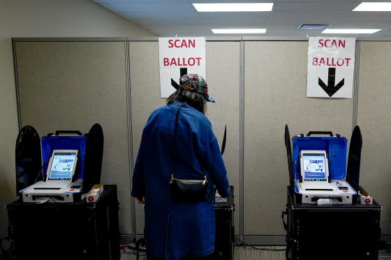Image: A voter casts a ballot during early voting in Cincinnati, Ohio, on March 14, 2020.
