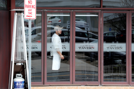 Image: FILE PHOTO: A worker looks out from a near empty restaurant on North Avenue during the coronavirus outbreak in New Rochelle
