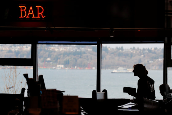 Image: A server works in the dining room of the Athenian Seafood Restaurant in Seattle