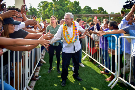 Image: Mexican President Andres Manuel Lopez Obrador shakes hands with supporters while visiting a town in Xochistlahuaca, Mexico, on March 14, 2020.