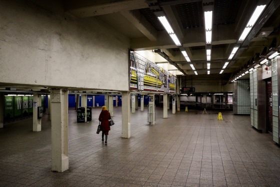 Image: A woman walks through the nearly empty Times Square subway station in New York on Thursday.