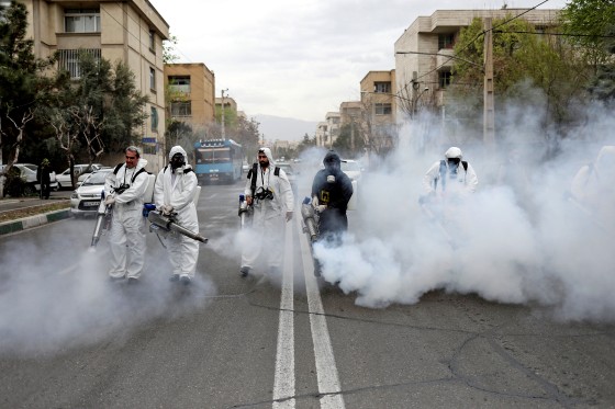 Image: FILE PHOTO: Members of firefighters wear protective face masks, amid fear of coronavirus disease, as they disinfect the streets, ahead of the Iranian New Year Nowruz, March 20, in Tehran