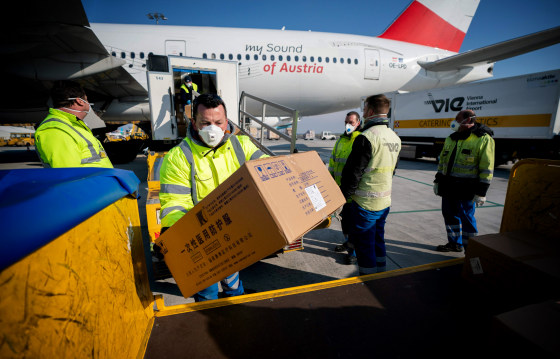Image: Workers unload protective equipment bound for Italy that arrived from China at the Vienna Airport in Austria on March 23, 2020.