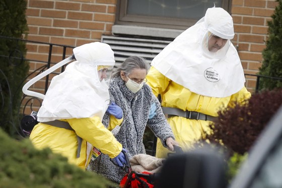 Image: Medical officials aid a residents from St. Joseph's nursing home to board a bus, after a number of residents tested positive for coronavirus disease (COVID-19) in Woodbridge, New Jersey