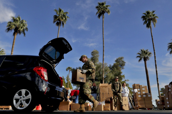 Image: Members of the Arizona National Guard distribute food in Mesa on March 27, 2020.