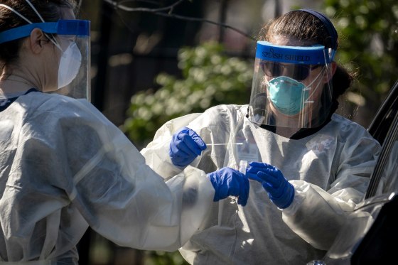 Image: Medical workers administer a coronavirus test at Trinity University in Washington, D.C., on April 2, 2020.