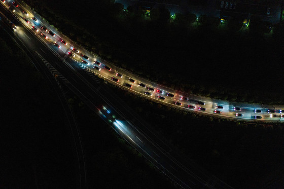 Image: Cars queuing at a highway toll station in Wuhan in China's central Hubei province, as they prepare to leave the city after authorities lifted a more than two-month ban on outbound travel