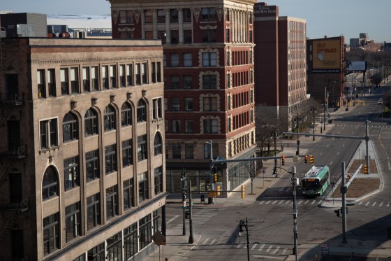 A bus travels along an empty street in Detroit