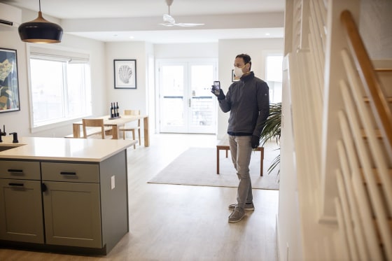Image: Tom Landry, broker and owner of Benchmark Real Estate, does a Facebook Live tour of a condo for sale in the East End of Portland