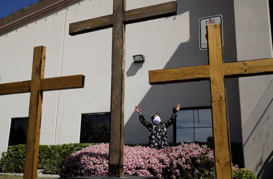 Image: Norma Urrabazo prays at an Easter drive-in service at the International Church of Las Vegas on April 12, 2020.