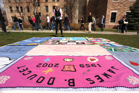 (HR) Gert McMullin looks at some of the quilts that are on display on the green grass outside of Norlin Library on the University of Colorado campus in Boulder. She was one out of the two first volunteers that started the AIDS Memorail Quilt project in Sa