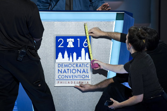 Image: Stage hands affix the DNC logo to the podium at the Democratic National Convention in Philadelphia
