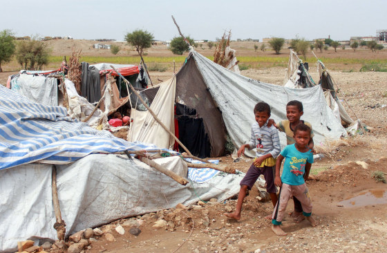 Image: Yemeni children play next to damaged tents due to torrential rain in a makeshift camp for the displaced in the northern Hajjah province