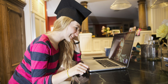 Young woman making video call with grandfather