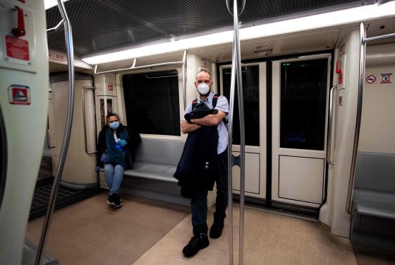 Image: Commuters stand in a coach during a test phase at the San Giovani underground metro station in Rome
