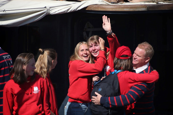 Image: Twenty-five Dutch students celebrate as relatives cheer them upon their arrival on the sailing ship Wylde Swan at the port of Harlingen