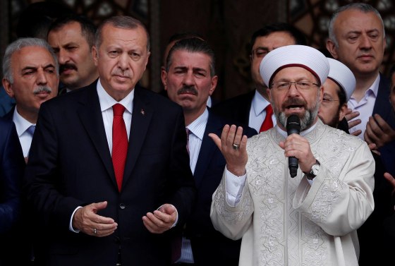 Image: Turkish President Tayyip Erdogan, accompanied by head of Turkey's Religious Affairs Directorate Ali Erbas, prays during the opening ceremony of a mosque in Istanbul, Turkey